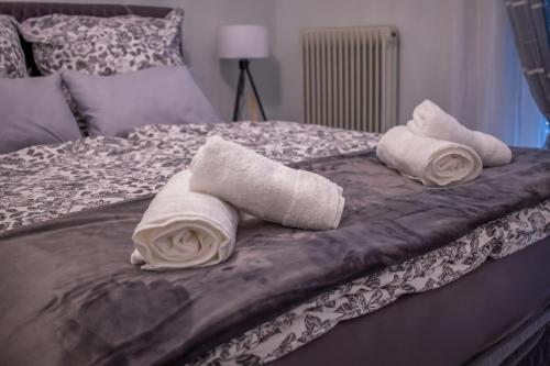 two rolled towels sitting on top of a bed at Anastasia Meteora Residence in Kalabaka