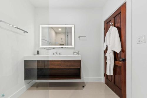 a bathroom with a sink and a mirror at Romora Bay Resort & Marina in Harbour Island