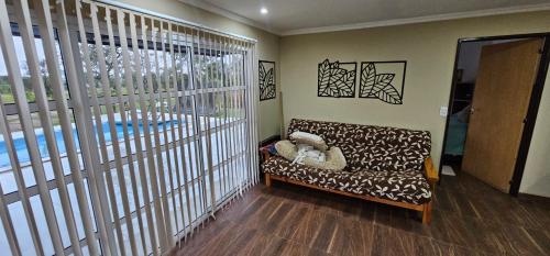 a living room with a couch and a large window at Aromas serranos in Villa Rumipal
