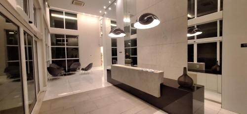 a lobby with a reception desk in a building at Ilha Pura Barra in Rio de Janeiro