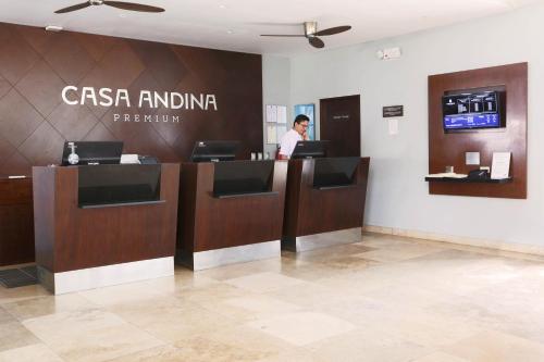 a man standing at a cash counter in a lobby at Casa Andina Premium Piura in Piura