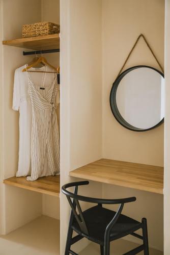 a black chair in a room with a mirror at Viento Luxury Apartments in Plomarion