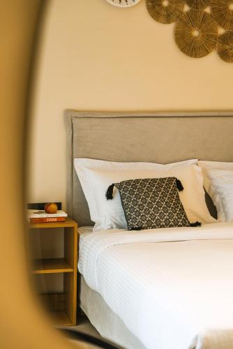 a bedroom with a bed and a nightstand next to it at Viento Luxury Apartments in Plomarion