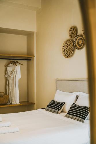 a bed with black and white pillows in a bedroom at Viento Luxury Apartments in Plomarion