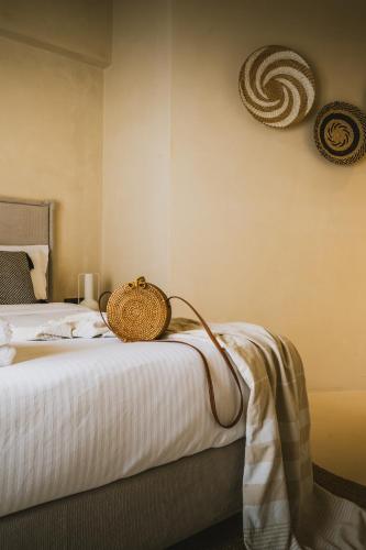 a bedroom with a bed with a basket on it at Viento Luxury Apartments in Plomarion