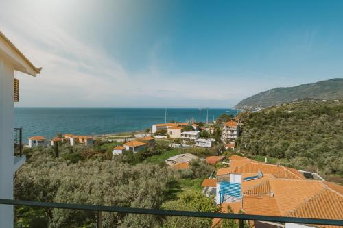 a view of a small town with the ocean at Viento Luxury Apartments in Plomarion