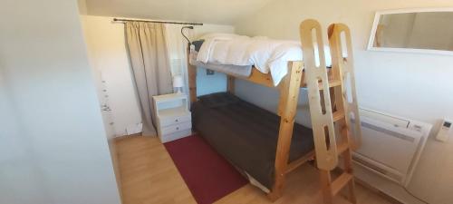 a small room with a bunk bed and a mirror at Βίλα Στέλλα Ιωάννης in Agia Pelagia