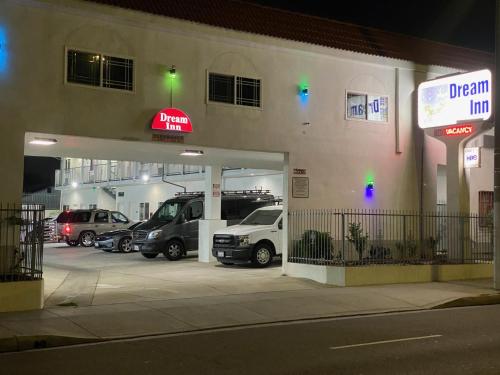 a car dealership with cars parked in a parking lot at Dream Inn in Inglewood