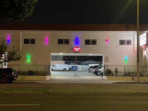 a building with a garage with cars parked in it at Dream Inn in Inglewood