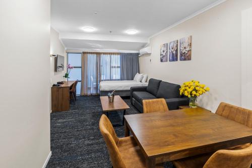 a living room with a couch and a table at Imperial Hotel Rotorua in Rotorua
