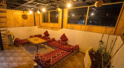 a room with couches and a table and windows at Fu SPACE in Tamraght Ouzdar