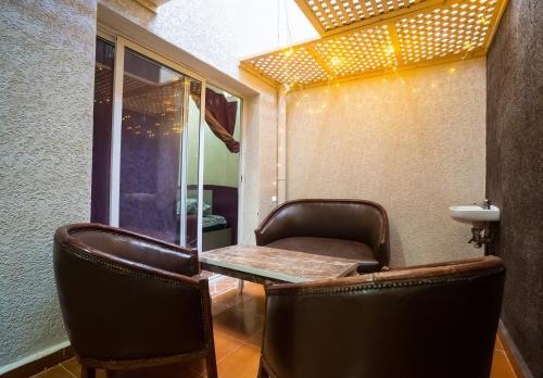 a barber shop with chairs and a table and a mirror at Fu SPACE in Tamraght Ouzdar