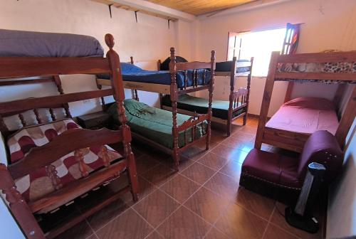 a room with several bunk beds in a room at Hostel VERBENITA in Humahuaca