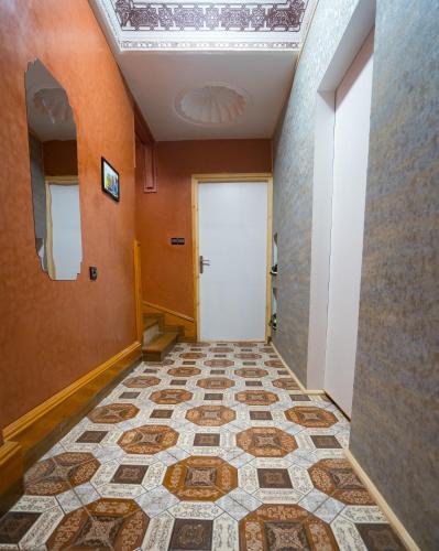 a hallway with a white door and a tile floor at Fu SPACE in Tamraght Ouzdar