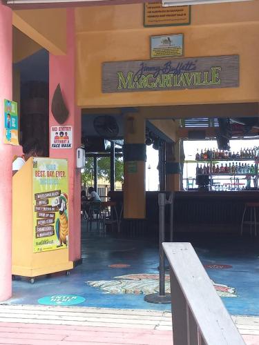 a restaurant with a sign on the front of a building at Towers by the Beach in Ocho Rios