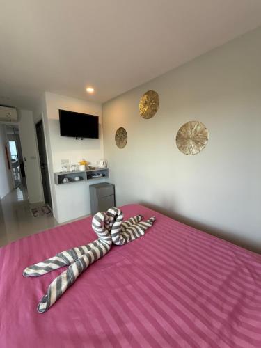 a towel is laying on top of a bed at BEACH Condo Mae Phim in Ban Tha Fat