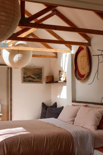 a bedroom with a bed in a room with wooden ceilings at The Casita at La Casa Cubo in Torquay