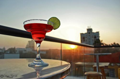 a martini glass with a lime on top of a table at Hotel Casa La Fe in Cartagena de Indias