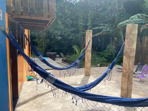a hammock on the patio of a house at Chalé lawill ilha do mel in Paranaguá
