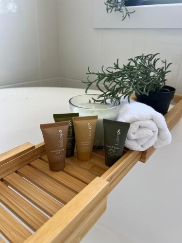 a tray with four cups on a table with plants at Amaroo holiday home in Kingscote