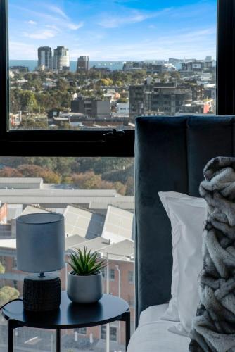 a living room with a view of a city from a window at Gorgeous 2bed 2bath apartment near Crown in Melbourne