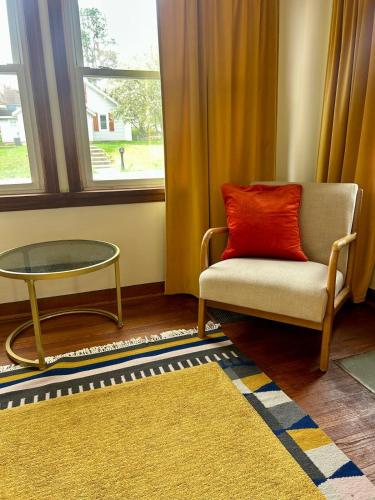 a room with a chair and a table and a window at Pleasant Mornings in Waynesville