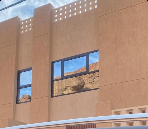 a building with three windows on the side of it at Mountain view in AlUla