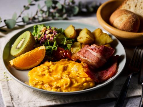 a plate of food with scrambled eggs and a salad at THE LIVELY TOKYO AZABUJUBAN in Tokyo