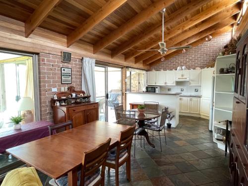 a kitchen and dining room with a table and chairs at BasinWaterStays Waterfront Jetty - Brm3 in Basin View