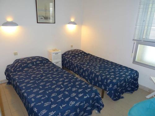 une chambre avec deux lits et une fenêtre dans l'établissement Appartement Climatisé avec WIFI et Animaux admis - Vue sur Mer - FR-1-833-19, à Canet