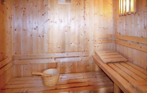 a wooden sauna with a bench and a basket at Gorgeous Home In Piegon With Sauna in Piégon