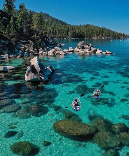 three people kayaking in a body of water at Cozy Cabin 5 Min Walk to Lake Tahoe Hot-Tub Excellent Location in Tahoe Vista