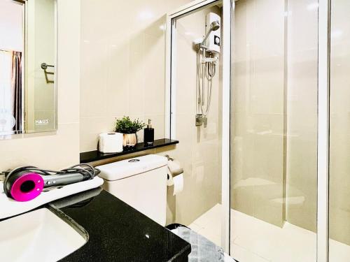 a bathroom with a toilet and a glass shower at Best Quiet Cozy Palm Springs Condo in Center Nimma in Chiang Mai