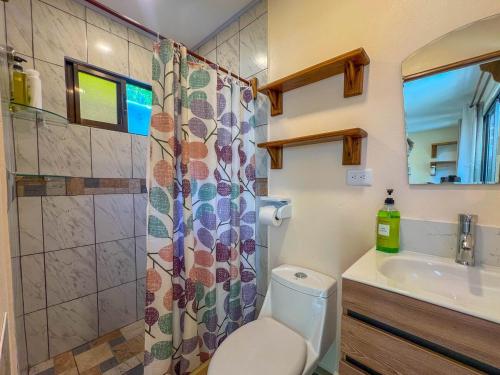 a bathroom with a toilet and a sink and a shower at Zaza Flats Jaco #5 New basic STUDIO APARTMENT - no extras, simple in Jacó