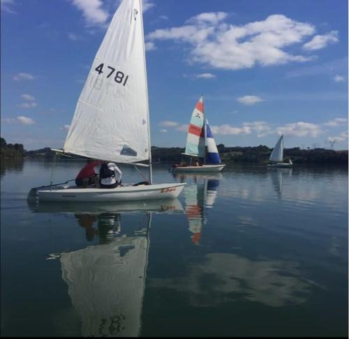a group of small sailboats on a body of water at Chácara Passaúna in Curitiba