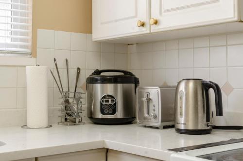a kitchen counter top with a toaster and a toaster at Convenient Urban Retreat in Vancouver