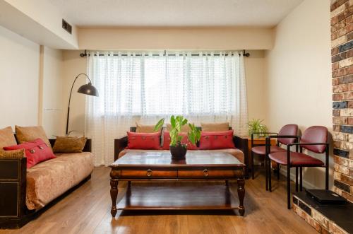 a living room with a couch and a table at Convenient Urban Retreat in Vancouver