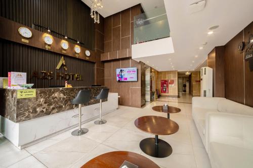 a hotel lobby with tables and a couch at A25 Hotel - 21 Le Duc Tho in Hanoi