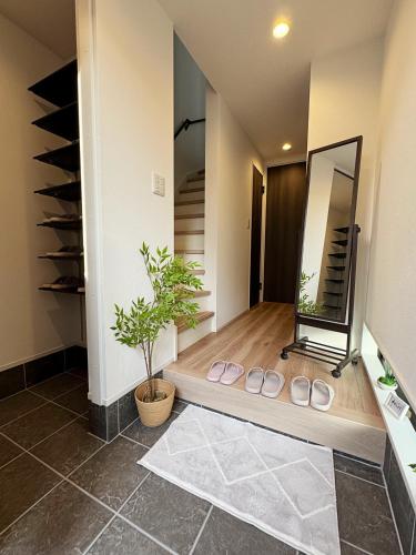a hallway with a mirror and a pair of slippers at 桜の川64 池袋駅C6口 8分 2-11人丨Ikebukuro JR Line C6 Exit 8 minutes 2-11 people in Tokyo