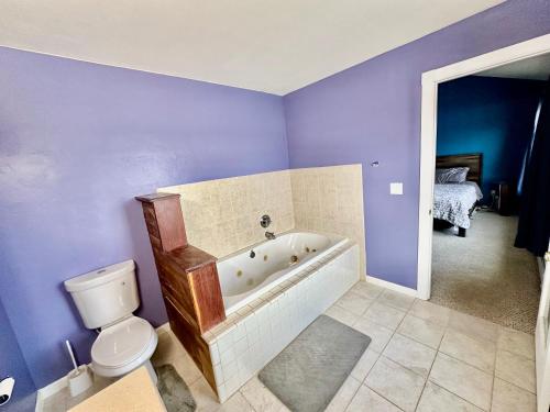 a bathroom with a bath tub and a toilet at Downtown Wasilla Lakefront Home in Wasilla