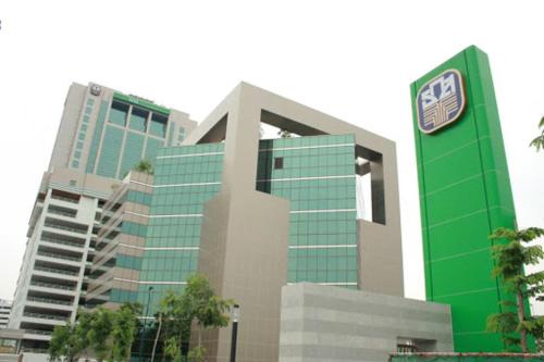 a large green building with a sign in front of it at Sky dome resotel - โรงแรมสกายโดม รีโซเทล in Bangkok