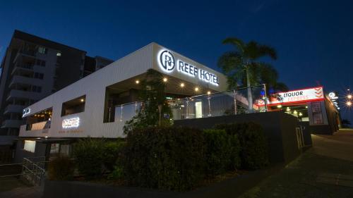 a building with a sign for a test house at night at Gladstone Reef Hotel Motel in Gladstone