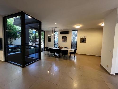a dining room and living room with a table and chairs at Super house- villa09 in Hod HaSharon