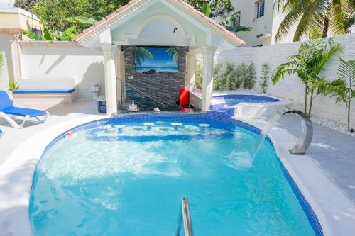 a pool with two water slides in a backyard at Villa La Dueña - Vista Hermosa Luxury Retreat, 5BR Villa with Pool, Swim-Up Bar, Jacuzzi, Chef's Kitchen, Fast Wi-Fi, Full AC, EV Charger and Solar Power, Ideal for Families & Groups in Cancino