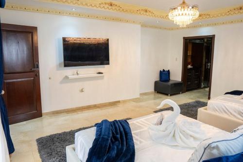 a living room with a swan on the floor at Villa La Dueña - Vista Hermosa Luxury Retreat, 5BR Villa with Pool, Swim-Up Bar, Jacuzzi, Chef's Kitchen, Fast Wi-Fi, Full AC, EV Charger and Solar Power, Ideal for Families & Groups in Cancino