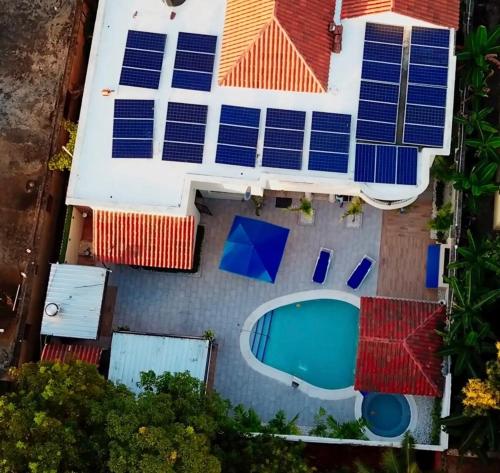 an overhead view of a house with solar panels on its roof at Villa La Dueña - Vista Hermosa Luxury Retreat, 5BR Villa with Pool, Swim-Up Bar, Jacuzzi, Chef's Kitchen, Fast Wi-Fi, Full AC, EV Charger and Solar Power, Ideal for Families & Groups in Cancino