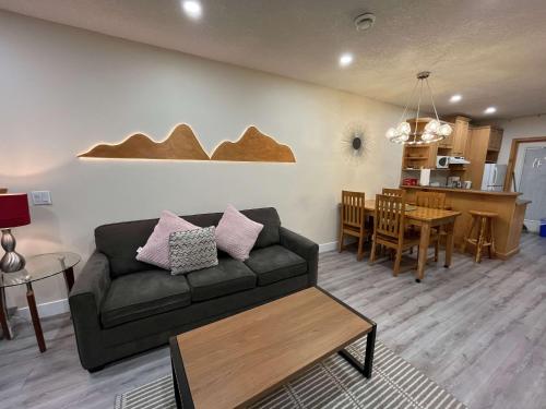 a living room with a couch and a table at Banff Woods lodge in Canmore