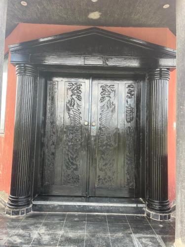 a large metal door in a building at Villa Mostafa Sadek, Swimming pool, Tennis & Squash - Borg ElArab Airport Alexandria in Borg El Arab