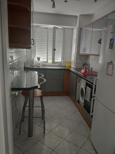 une petite cuisine avec une table et un réfrigérateur dans l'établissement 3 pièces 67m2 centre ville très lumineux et calme, à Nice