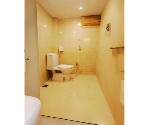 a bathroom with a toilet and a shower at Garden View Villa in Rājshāhi